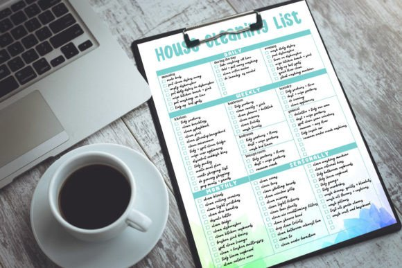 A printed page of a printable retro home cleaning checklist with a laptop and coffee cup in the background.