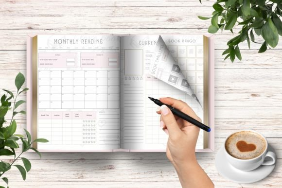 A woman's hand filling a page of a printed reading journal with a pen within the monthly reading journaling framework.